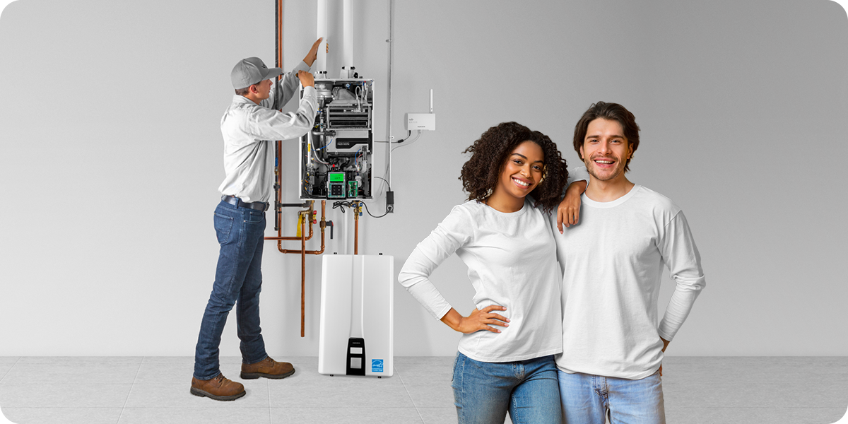 A technician installing a wall-mounted Navien tankless water heater beside two homeowners